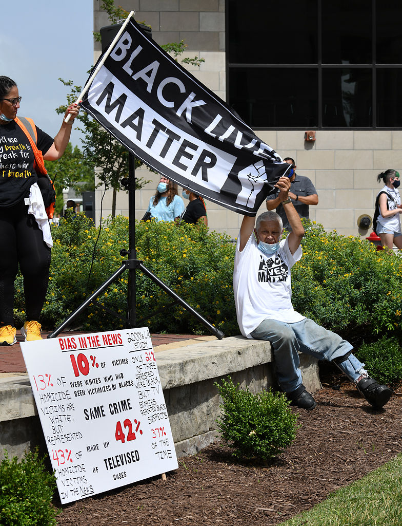 Long time Columbia activist Bill Easley holds up a Black Lives Matter banner on Sunday
